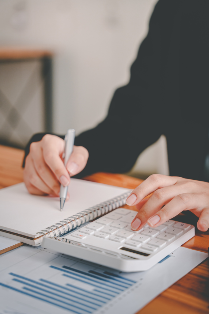 business woman or accountant who are using a calculator to calculate business data Accounting docume