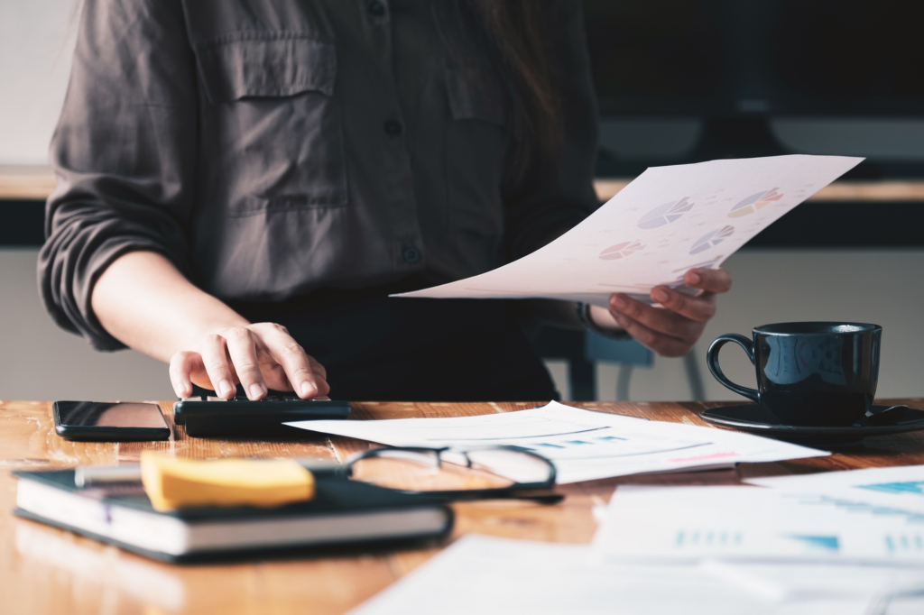 Close up view of bookkeeper or financial inspector hands making report,